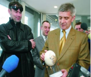 Prezes Rady Ministrów Marek Belka z autorem swej karykatury wykonanej na sytrusim jaju